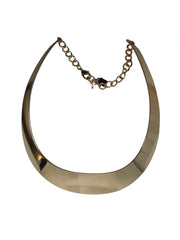 Gold necklace with a large circular pendant on a white background