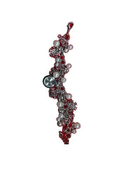 Jewelry piece with red and silver elements on a white background